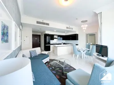 a living room with a couch and a table at Luxury Living Skyline Views l 2BR with Pool & Gym in Dubai