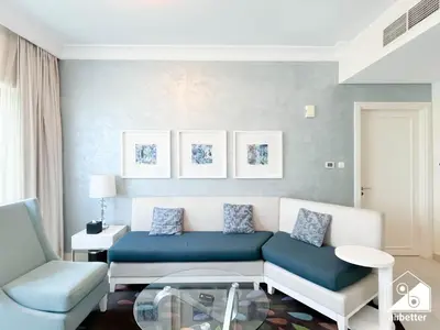 a living room with a couch and a chair at Luxury Living Skyline Views l 2BR with Pool & Gym in Dubai