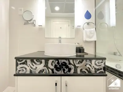 a white bathroom with a sink and a counter at Luxury Living Skyline Views l 2BR with Pool & Gym in Dubai