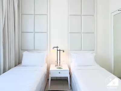 two beds sitting next to each other in a room at Luxury Living Skyline Views l 2BR with Pool & Gym in Dubai