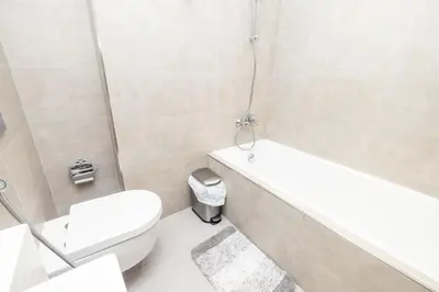 a bathroom with a toilet and a tub and a sink at Modern & Luxurious 2BR Penthouse in MBR City District One Dubai in Dubai