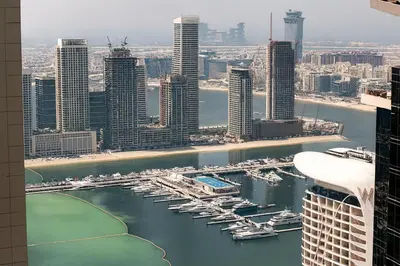 a view of a harbor with boats in a city at Marina 2BR 58th Floor Sea and City Views Pool Gym in Dubai
