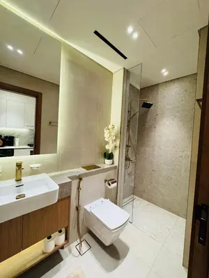 a bathroom with a toilet and a sink and a shower at Luxury Studio in JVC Near Marina & Downtown in Dubai