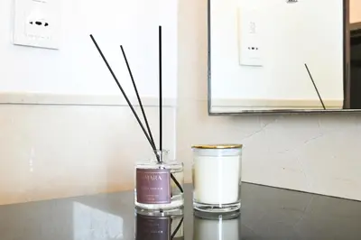 two vases with sticks in them on a table at MarvelStay - Connected to Mall & Metro - JW Marriott in Dubai