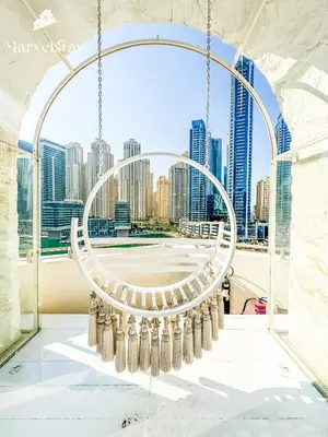 a view of the city through an arch in a building at MarvelStay - Connected to Mall & Metro - JW Marriott in Dubai
