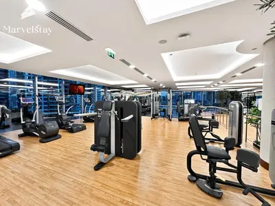 a gym with treadmills and chairs in it at MarvelStay - Connected to Mall & Metro - JW Marriott in Dubai