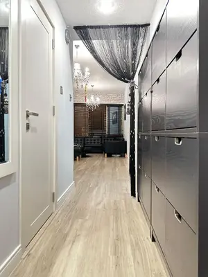 a room with a hallway with wooden floors and a living room at JLT Luxury New 2BHK in Dubai