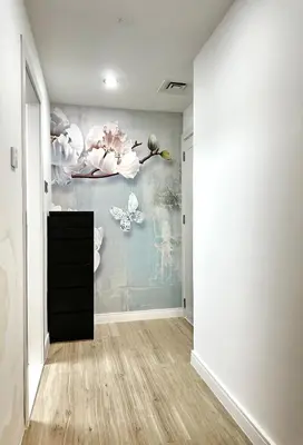 a room with a painting of butterflies on the wall at JLT Luxury New 2BHK in Dubai