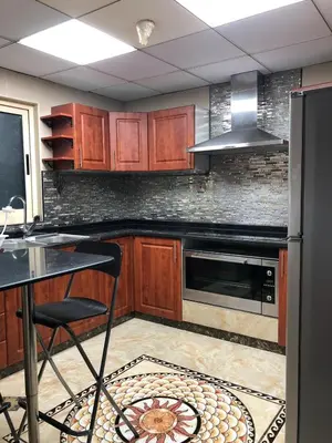 a kitchen with wooden cabinets and a stove top oven at JLT Luxury New 2BHK in Dubai