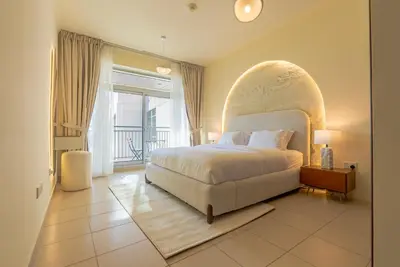 a bedroom with a large bed and a large window at Grand 1bhk burj khalifa view Downtown in Dubai