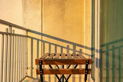 a wooden bench sitting on the side of a building at Grand 1bhk burj khalifa view Downtown in Dubai