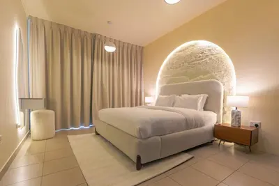 a bedroom with a large bed and a large window at Grand 1bhk burj khalifa view Downtown in Dubai