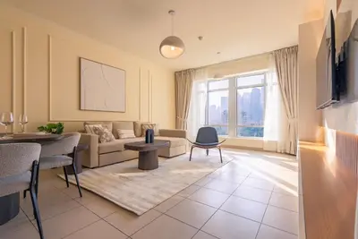 a living room with a couch and a table at Grand 1bhk burj khalifa view Downtown in Dubai