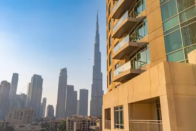 a tall building in front of a city skyline at Grand 1bhk burj khalifa view Downtown in Dubai