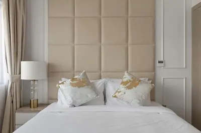 a bed with white sheets and pillows in a bedroom at Luxury 4BR Villa Free Malibu Beach Access in Dubai