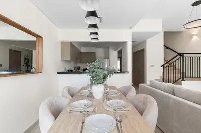 a dining room with a table and chairs at Luxury 4BR Villa Free Malibu Beach Access in Dubai