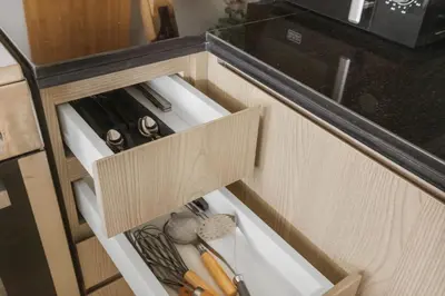 an open drawer in a kitchen with some utensils at Luxury 4BR Villa Free Malibu Beach Access in Dubai