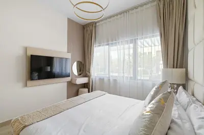 a bedroom with a bed and a large window at Luxury 4BR Villa Free Malibu Beach Access in Dubai