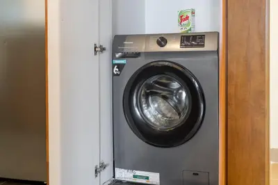 a washing machine in a door of a room at Luxury JLT 1BR 2 Beds in Room Lakeview & Pool in Dubai