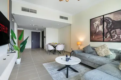 a living room with a couch and a table at Luxury JLT 1BR 2 Beds in Room Lakeview & Pool in Dubai
