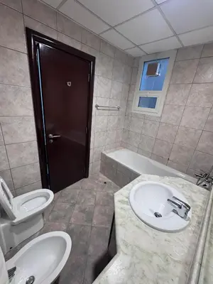 a bathroom with a sink and a toilet and a tub at Comfort Ensuite with Balcony in Dubai