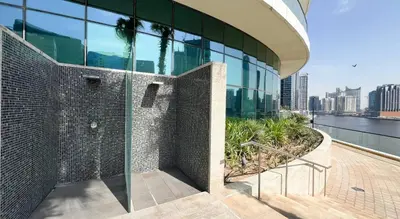 a shower in the side of a building at Poolside Studio with Canal Views and Near Dubai Mall in Dubai