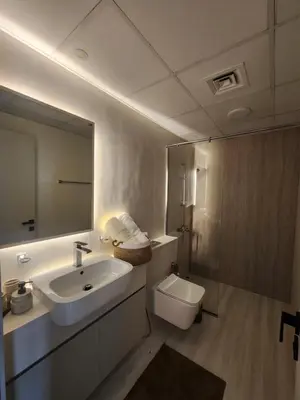 a bathroom with a sink and a toilet and a mirror at City View Apartment very Close to Downtown and World Trade Center DIFC in Dubai