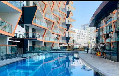 a building with a swimming pool in front of a building at City View Apartment very Close to Downtown and World Trade Center DIFC in Dubai