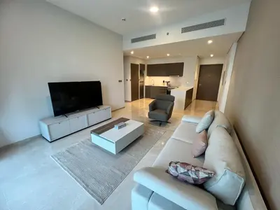 a living room with a couch and a flat screen tv at Grande in Dubai