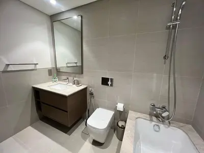 a bathroom with a toilet and a sink and a shower at Grande in Dubai