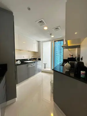 a large kitchen with a counter top in a room at Damac Maison Prive in Dubai