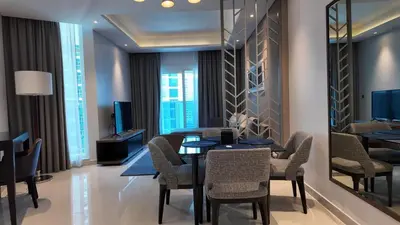 a dining room with a table and chairs at Damac Maison Prive in Dubai
