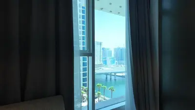 a room with a window with a view of a building at Damac Maison Prive in Dubai