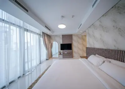 a bedroom with a large bed and a large window at Amazing Burj Khalifa Views with Highest Infinity pool in Dubai