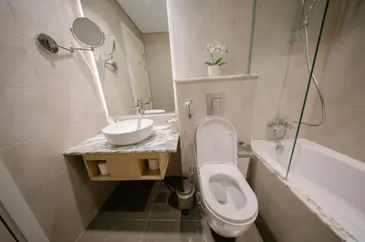 a bathroom with a toilet and a sink and a tub at Amazing Burj Khalifa Views with Highest Infinity pool in Dubai