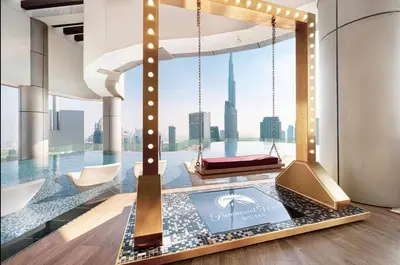 a lobby with a view of the city at Amazing Burj Khalifa Views with Highest Infinity pool in Dubai
