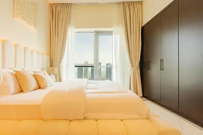 a bedroom with a large bed with a large window at Bright 1bhk Full Marina View in Dubai