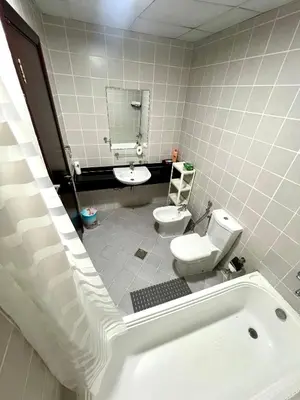 a bathroom with a tub and a toilet and a sink at Stylish 1-Bedroom Apartment in the Heart of Dubai Marina in Dubai