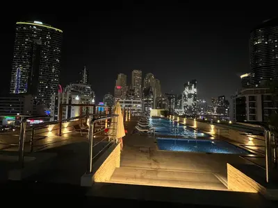 a view of a city skyline at night at Stylish 1-Bedroom Apartment in the Heart of Dubai Marina in Dubai