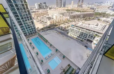 a view of a city from a building at Cozy Apartment Gym and Pool Heart of JVC in Dubai