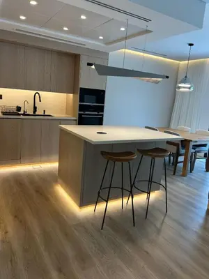 a kitchen with a island with bar stools at Architect Designed house 2 BR with Private Pool in Dubai