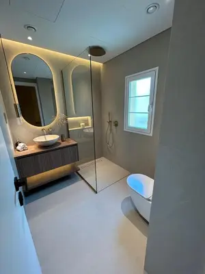 a bathroom with a toilet and a sink and a mirror at Architect Designed house 2 BR with Private Pool in Dubai