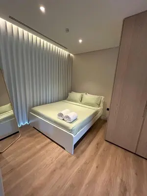 a bedroom with a bed with white sheets and a window at Architect Designed house 2 BR with Private Pool in Dubai
