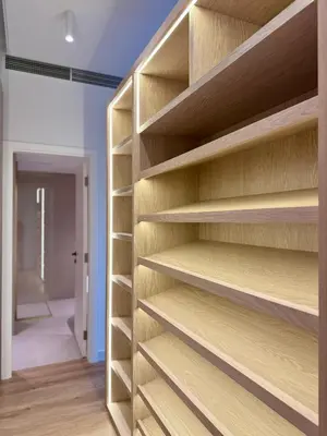 a book shelf in a room with a hallway at Architect Designed house 2 BR with Private Pool in Dubai