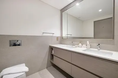 a bathroom with a sink and a mirror at Grande Altura Burj & Fountain view 57 floor in Dubai