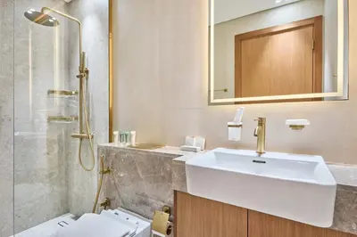 a bathroom with a sink and a shower and a toilet at 1BR Apartment with Private Jacuzzi & Burj Khalifa Skyline in Trillionaire Residences By Binghatti in Dubai
