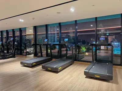 a gym with treadmills and exercise equipment in a building at 1BR Apartment with Private Jacuzzi & Burj Khalifa Skyline in Trillionaire Residences By Binghatti in Dubai