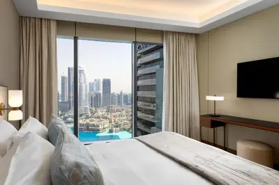 a hotel room with a bed and a large window at Maison Privee - Fabulous Apt with Sensational Burj Khalifa Views in Dubai