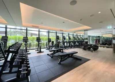 a gym with rows of exercise bikes and treadmills at Maison Privee - Fabulous Apt with Sensational Burj Khalifa Views in Dubai