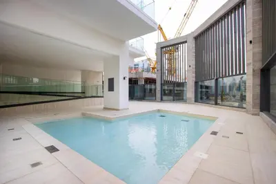 a swimming pool in the middle of a building at 1BR Paragon Tower Burj Khalifa & Canal Views in Dubai